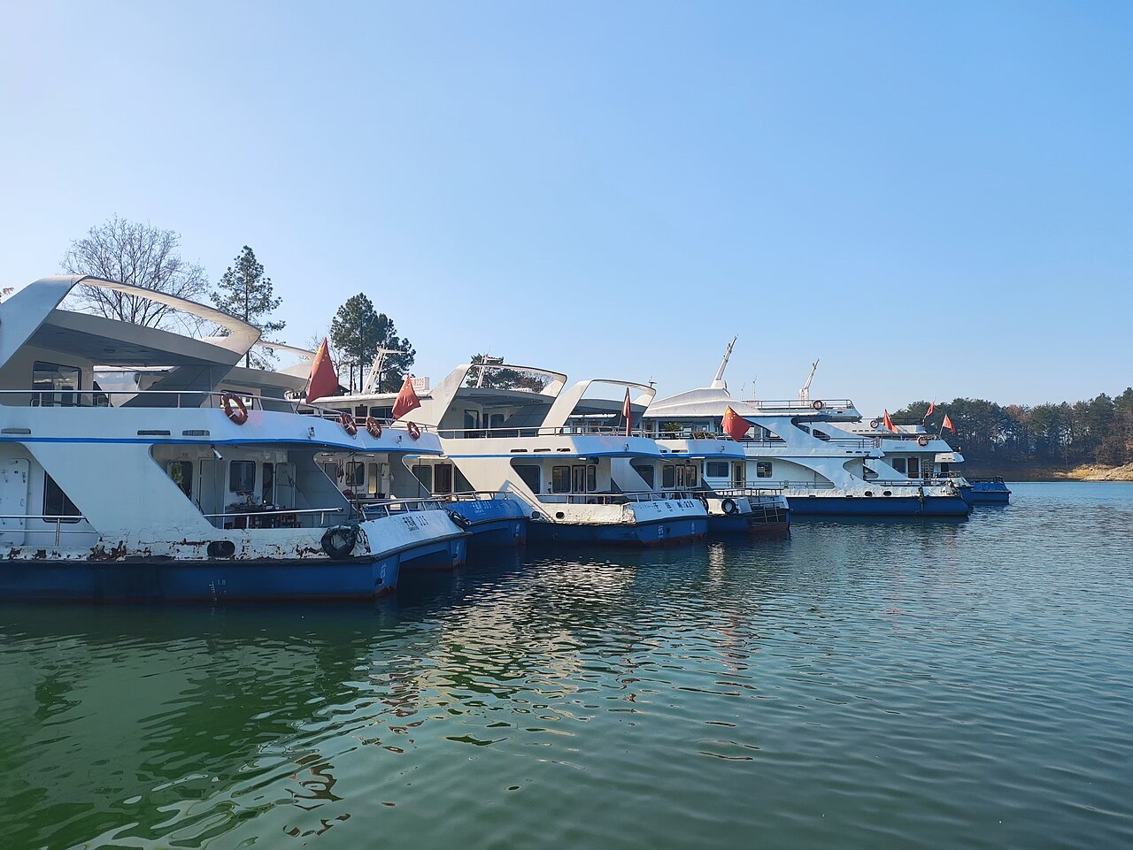 A cruise boat leaving the tourism pier in the morning